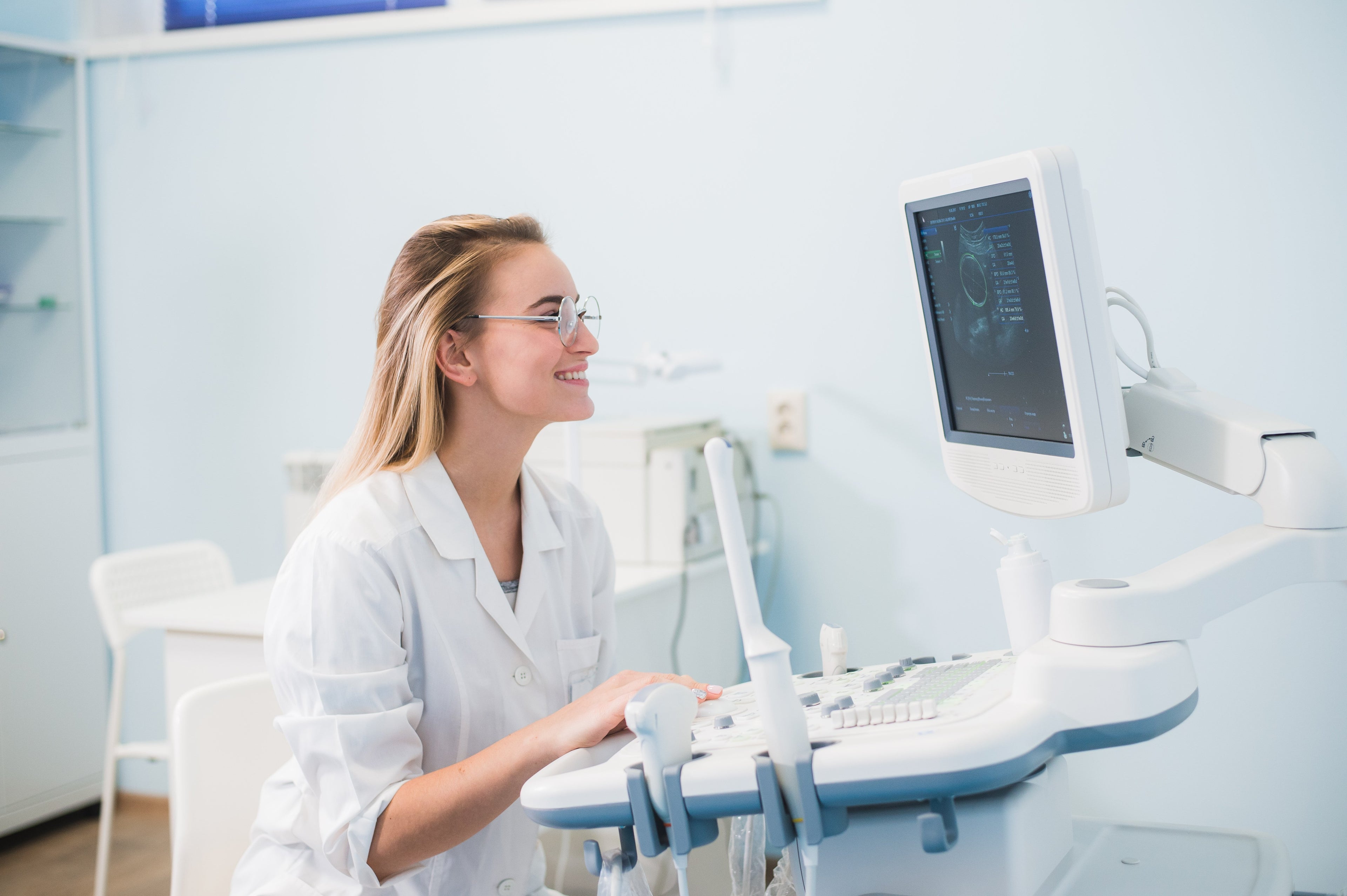 female doctor using a stationary ultrasound machine